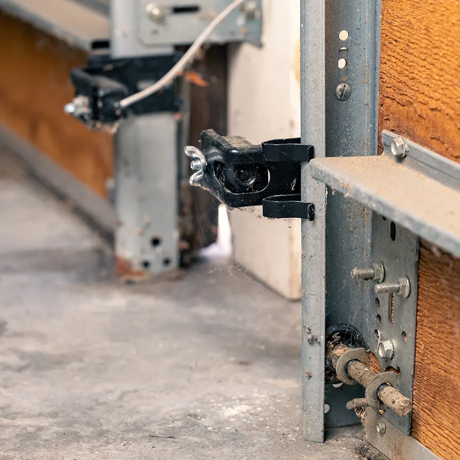 Garage door safety sensor on wooden door