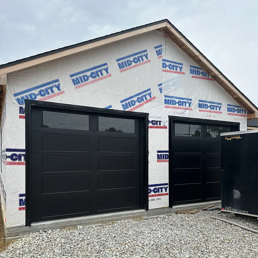 Pair of newly installed garage doors in home under construction