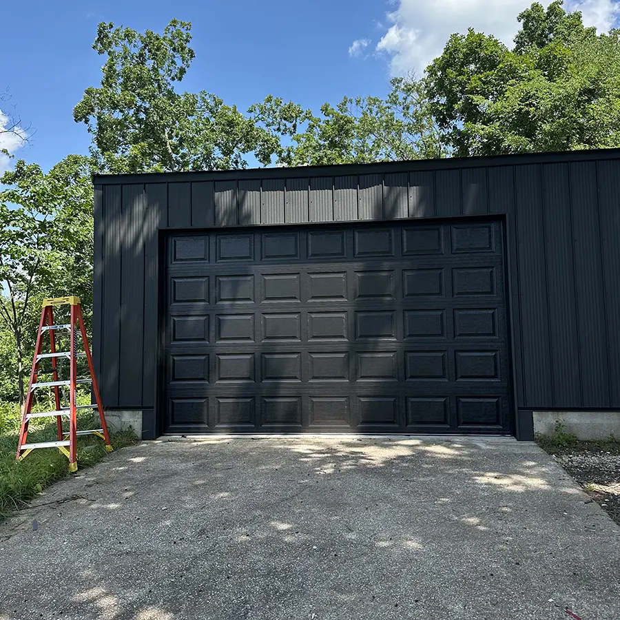 Black garage door replacement matching garage paint job