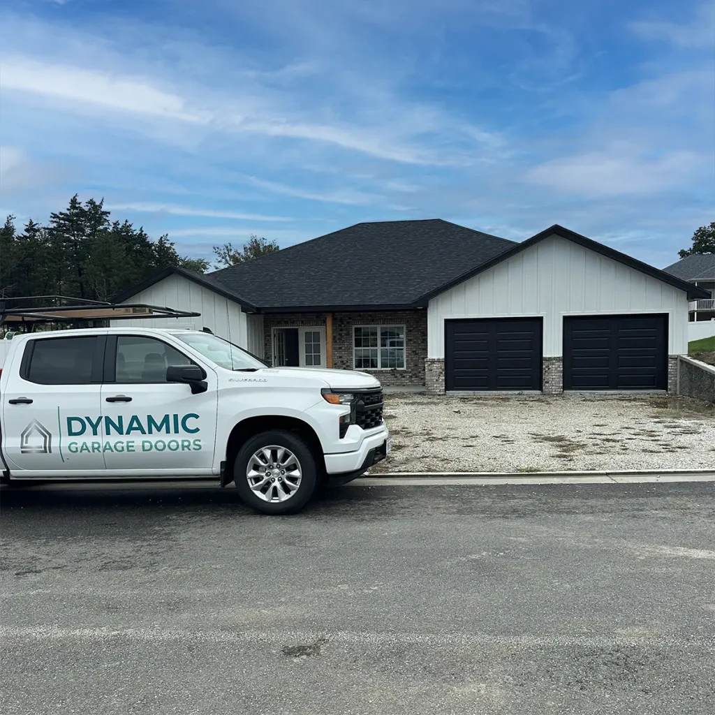 Dynamic Garage Door truck parked in front of a house with new garage doors