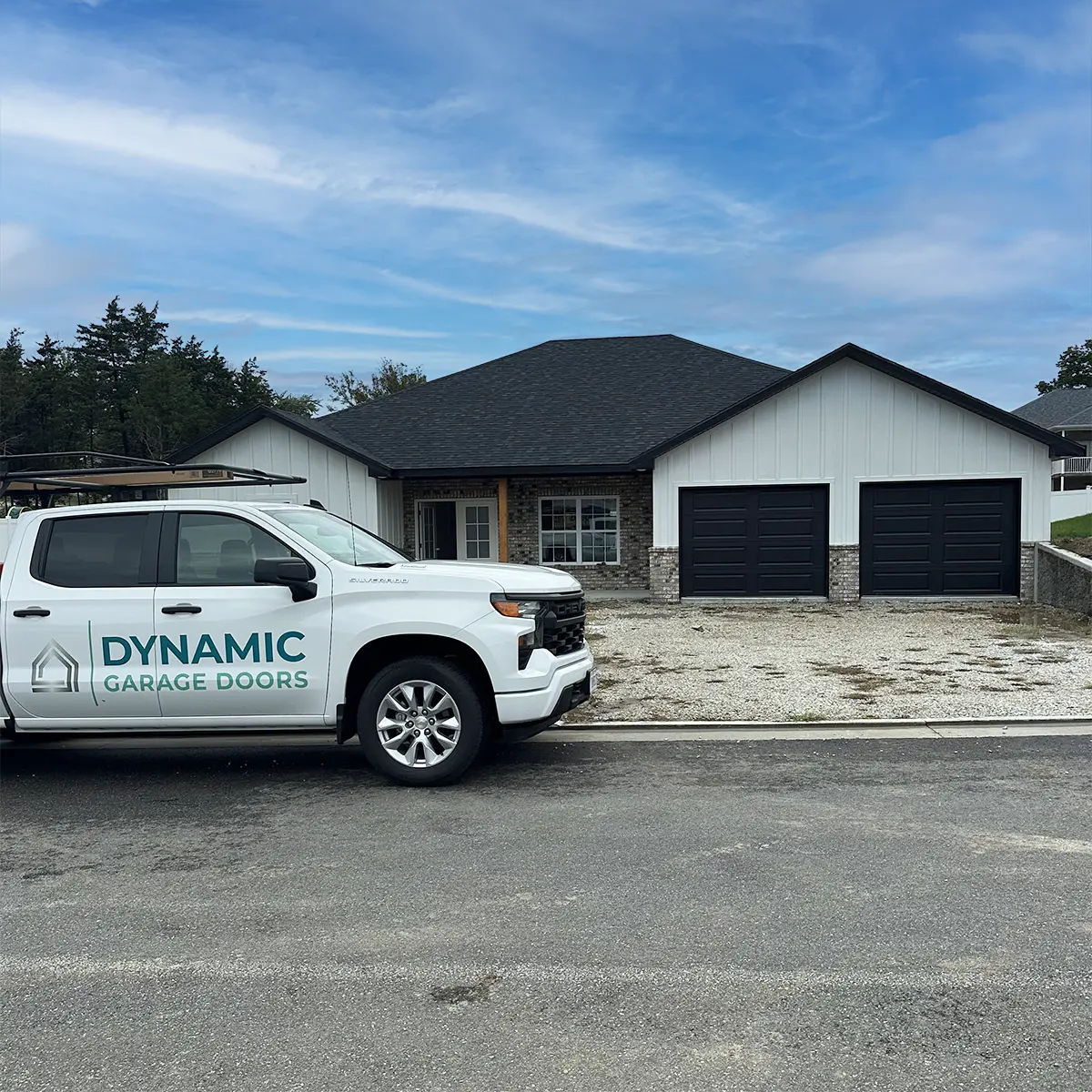 Dynamic Garage Door truck parked in front of a house with new garage doors